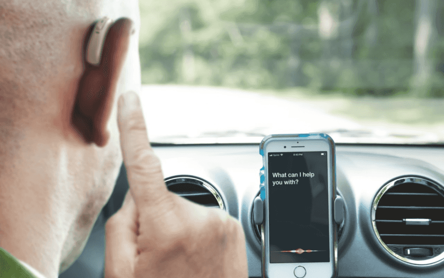 Man use phonak hearing aids car with siri